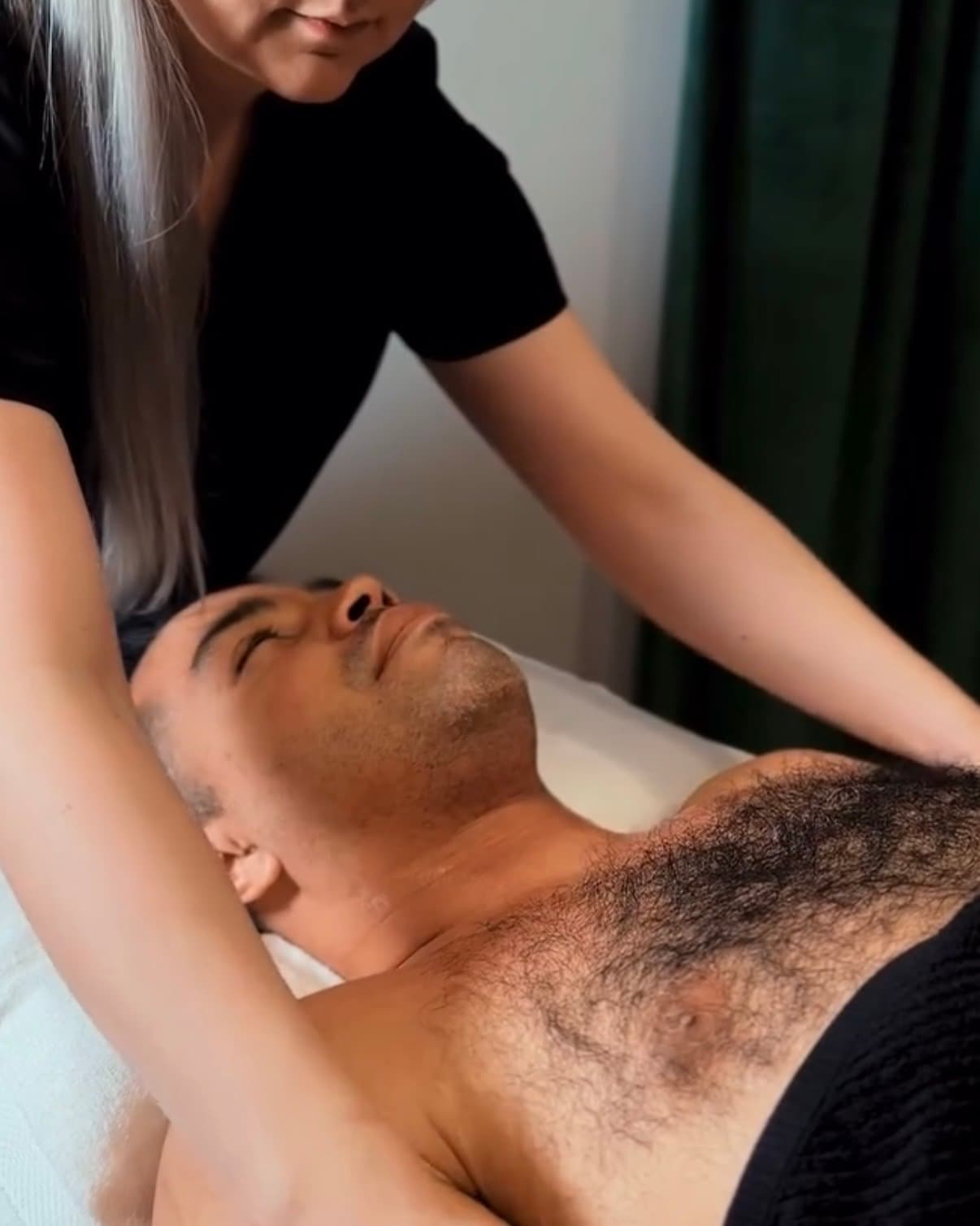 Massage therapist at work with a client on the table, shot for a massage clinic